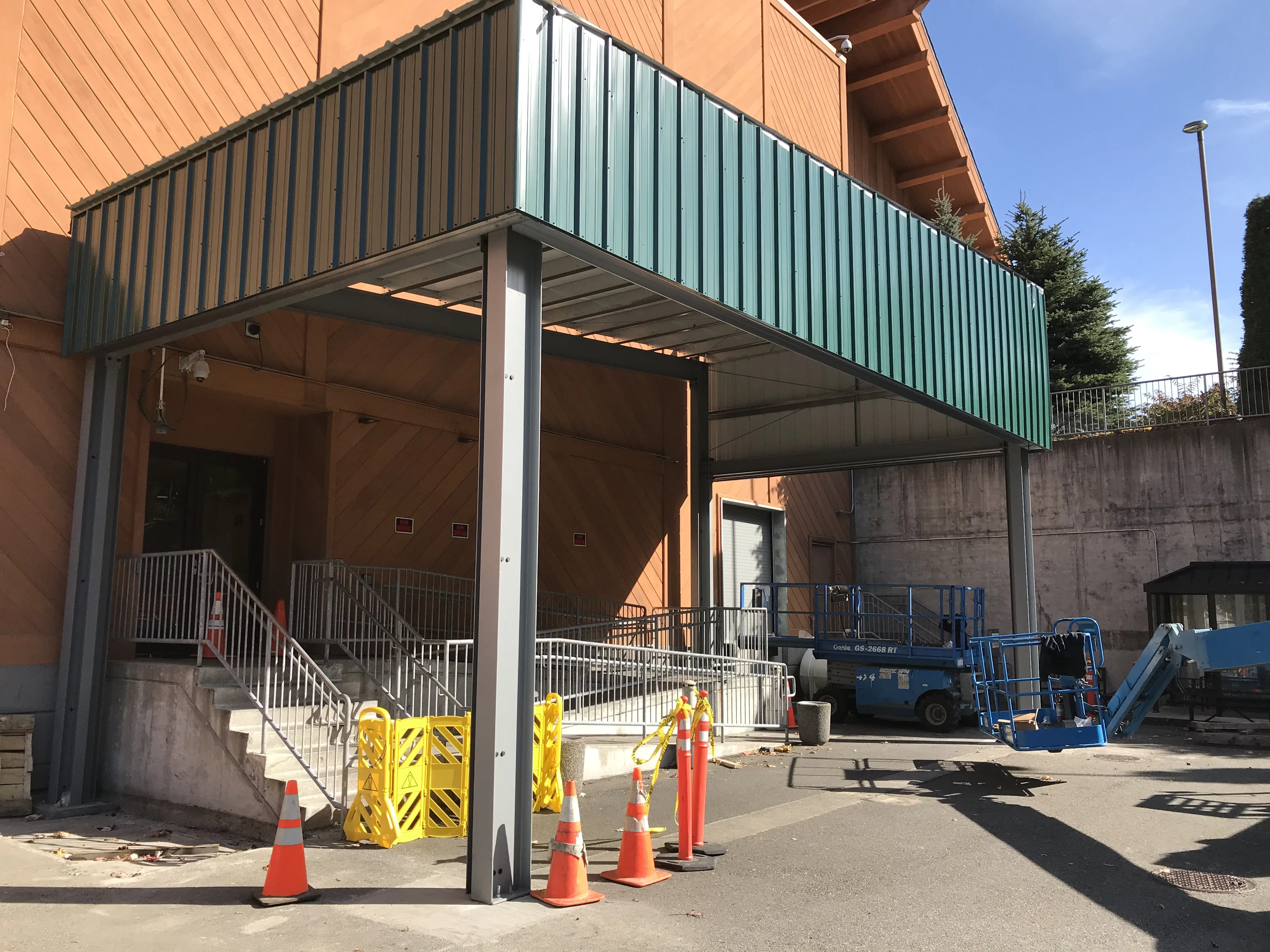 Entry canopy with corrugated metal panels and ADA-compliant access