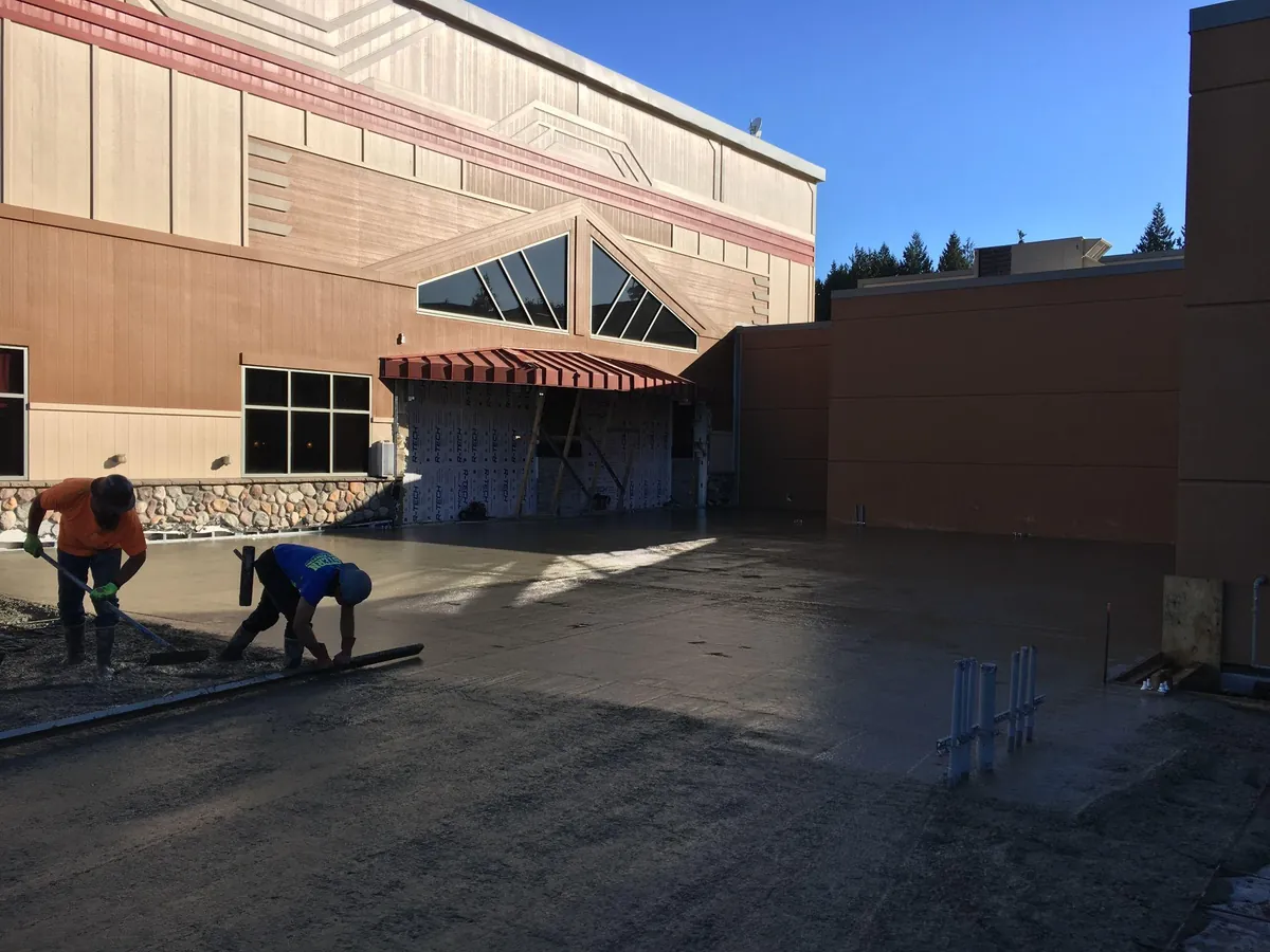 Fresh concrete flatwork at a commercial building entry area in Western Washington
