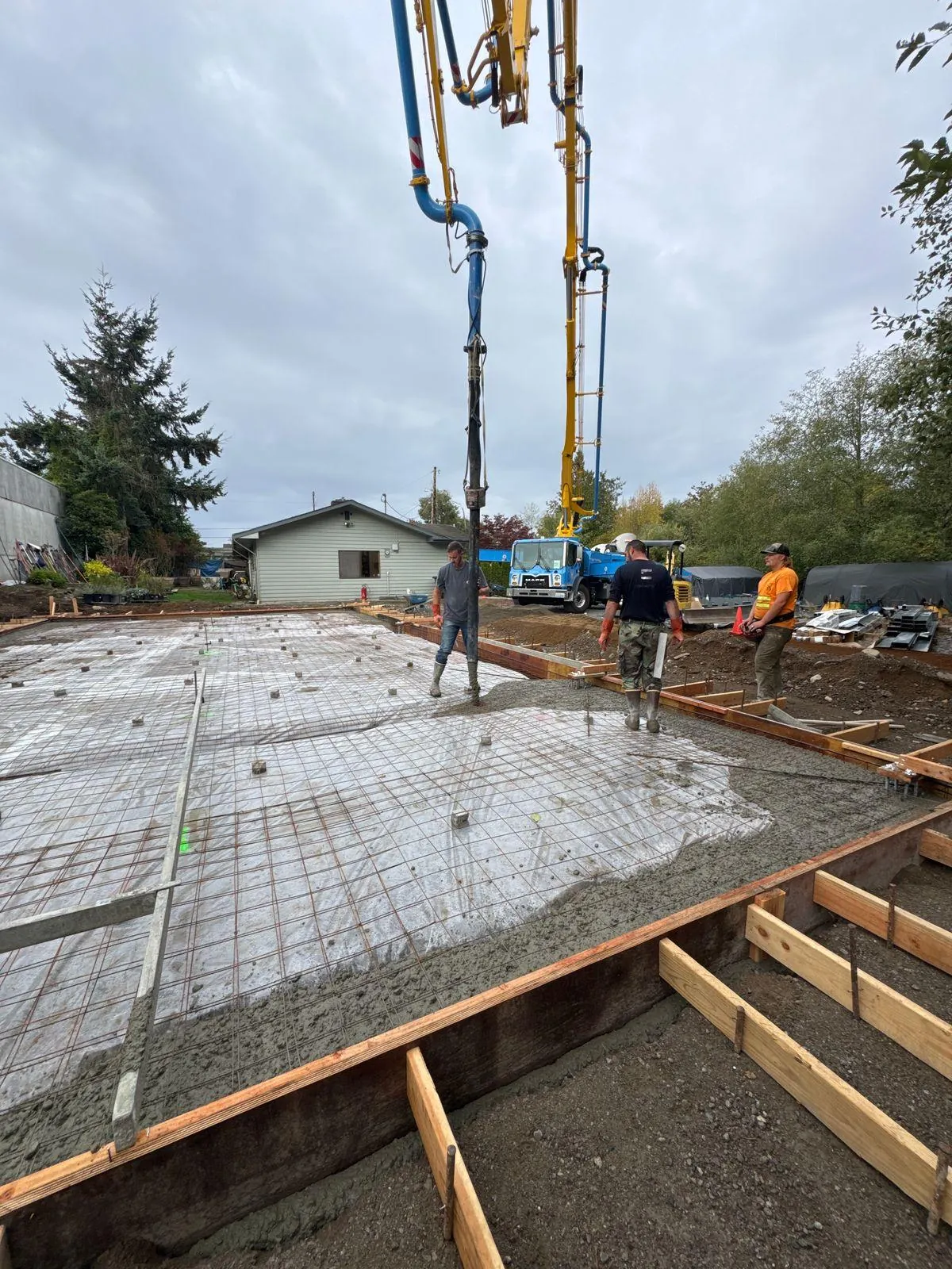 Concrete placement underway for the Somerset Gardens metal shop foundation in Edmonds.