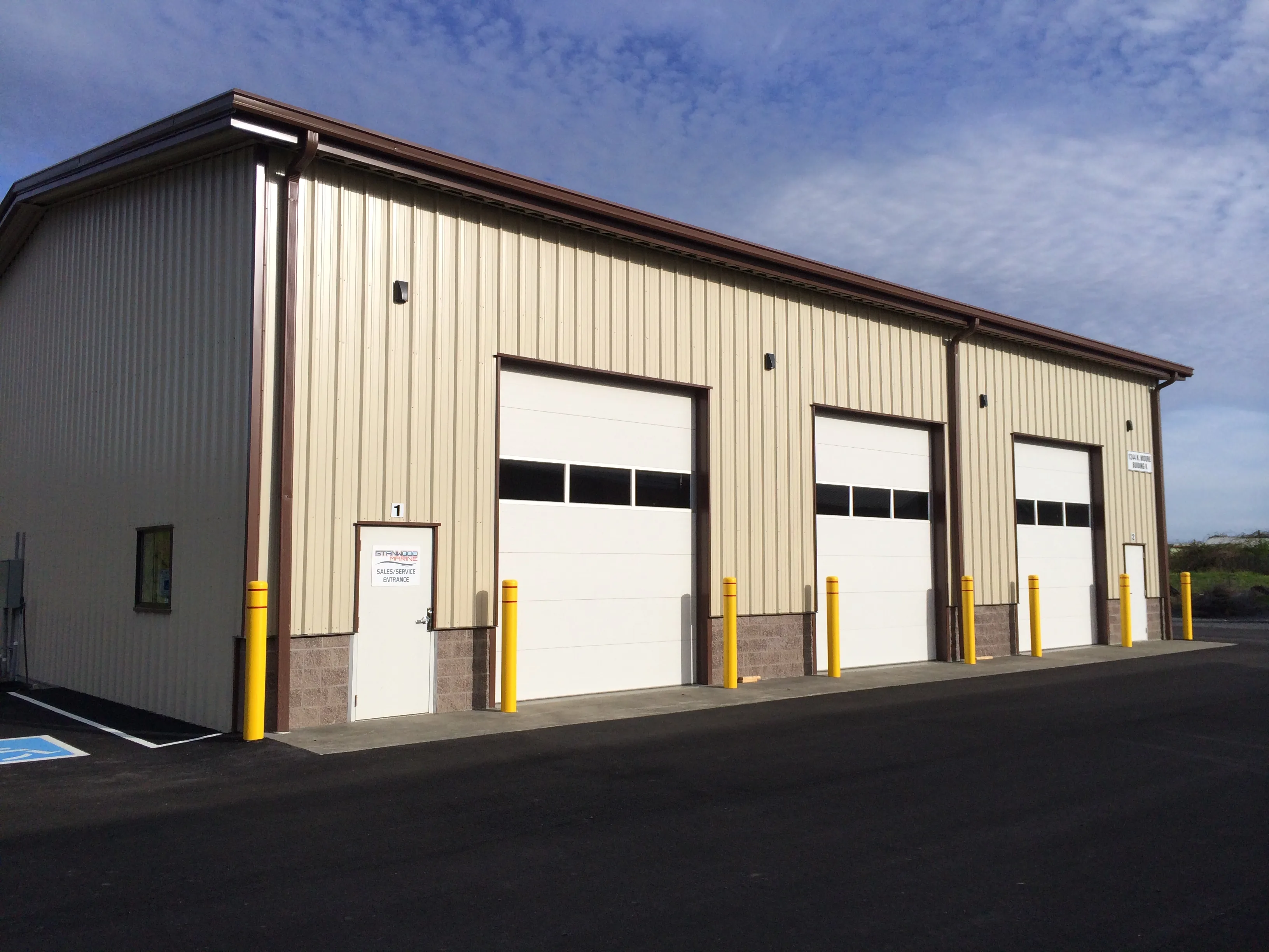 Completed commercial steel building with overhead bay doors